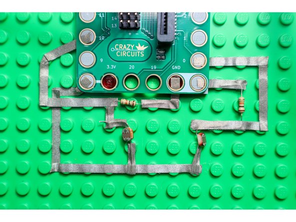 Build the circuit as shown with two Light Detecting Resistors and two 10K Ohm Resistors.