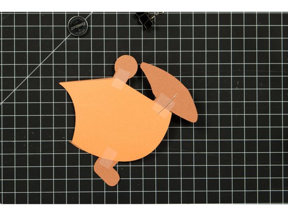 Run a piece of tape covering the positive LED leg, down and then over to the round battery holder piece.