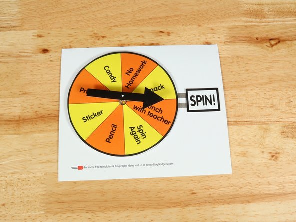 Add another square of double-sided tape onto the shaft of the motor, and then stick the arrow to it.