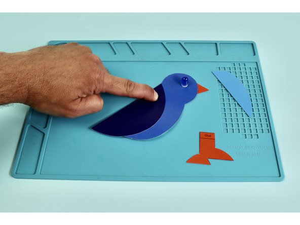 Use glue to assemble the tail, wing, feet, and beak to the body.