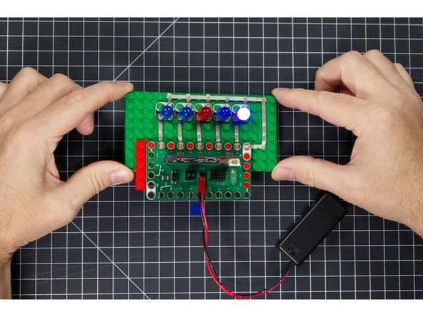 Try picking up the level and tilting left, and then right, and then trying to keep it level. If you get it level the center LED should light up.