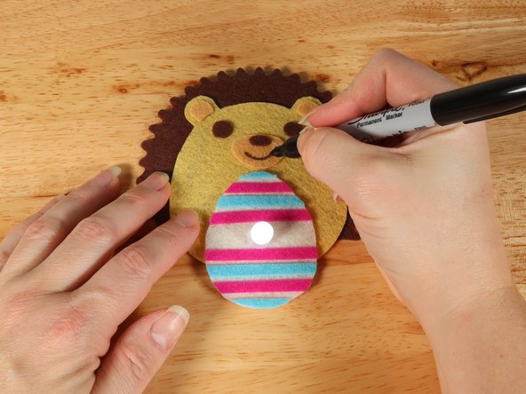 Use a black permanent marker to draw a mouth on the Hedgehog.