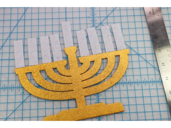 Cut out the &quot;candle&quot; rectangles from the white glitter felt.