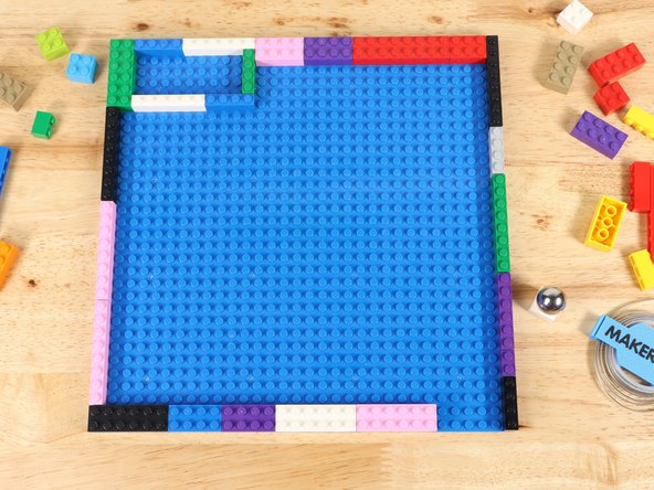 Use LEGO bricks to build a border around the outside edge of a 32x32 LEGO baseplate.