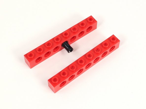 Add a second 1x8 brick with holes to the other side of the black pin.