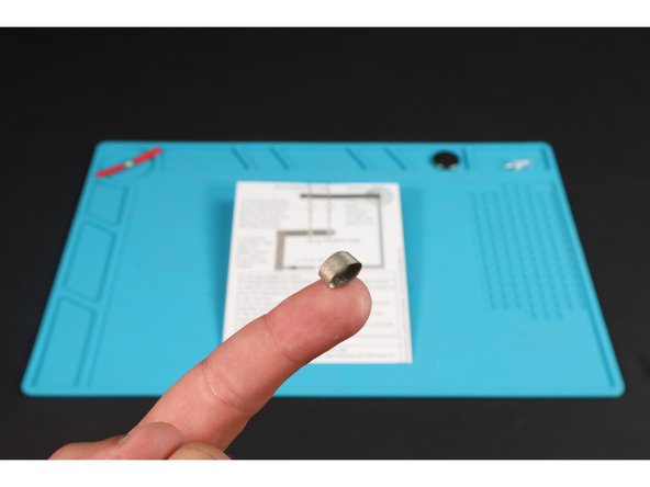 Cut a short length of Maker Tape and roll it into a loop (sticky side out).