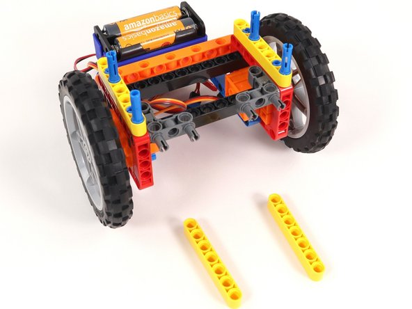 Add another yellow beam onto each set of blue pins.