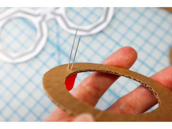 Push the LEDs through the holes on the frames, with the Positive (Long Leg) facing away from the center.