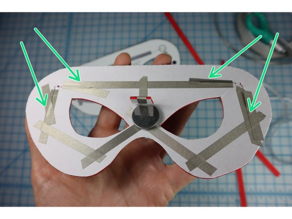 Add a piece of Maker Tape on top of the LED legs as shown.