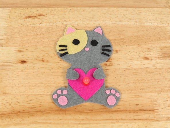 If you are using Elmers or Tacky glue, you will need to use something to hold the paws in place until it dries. Binder clips work well for this.