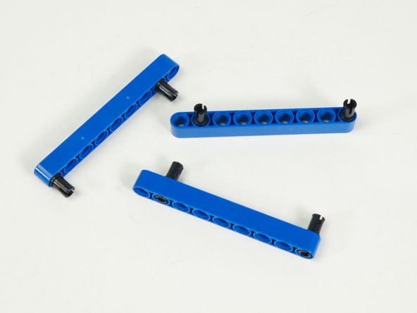 One pin goes at one end, and the other goes in the second hole on the opposite end.