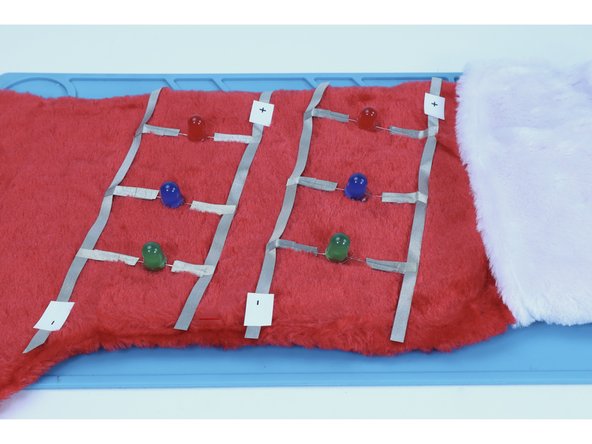 When finished, all of your LEDs legs should be electrically connected to the longer outer paths as pictured in photo 3.