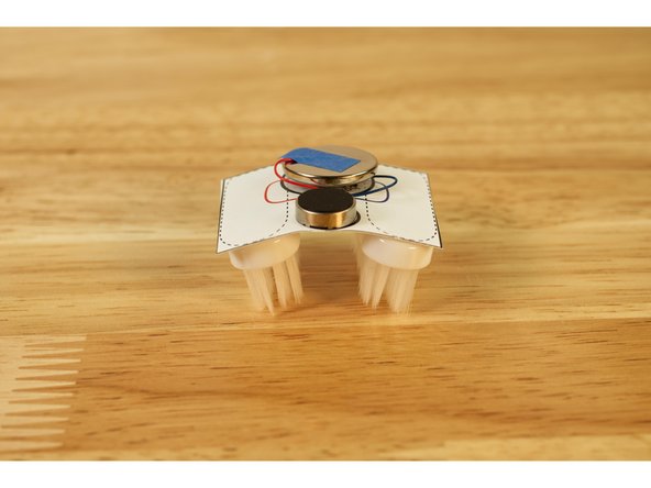 Try bending the bot at the center so the body is convex or concave. Test it out, and see which works better for faster motion.