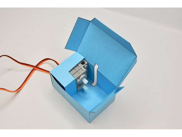 You only need to put glue on the tabs, not on the servos themselves.