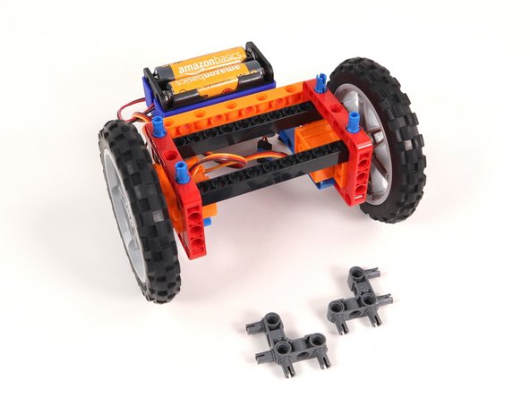 Add two gray 90° connectors to the Rover as shown. One side should connect to the inside of a red frame and the other pins should stick out towards the front of the Rover.