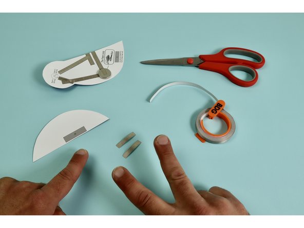 Measure, cut, peel, and stick a piece of Maker Tape down as indicated atop the letter 'G.' on the back side of the wing.