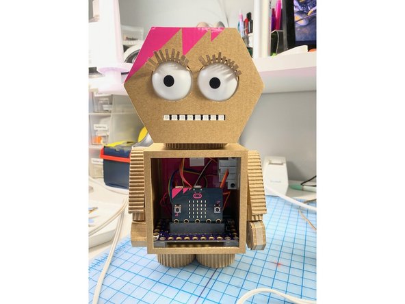 We made her some eyelashes out of the paper that was torn off of the cardboard. We glued them on using white glue, but the process felt a lot like gluing on real false eyelashes!