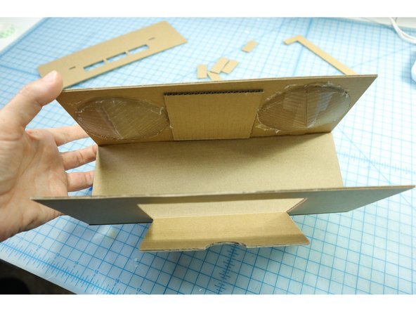 Glue the bottom and back pieces in place. It can be helpful to use a box or other 90 degree angled object to align the angle.