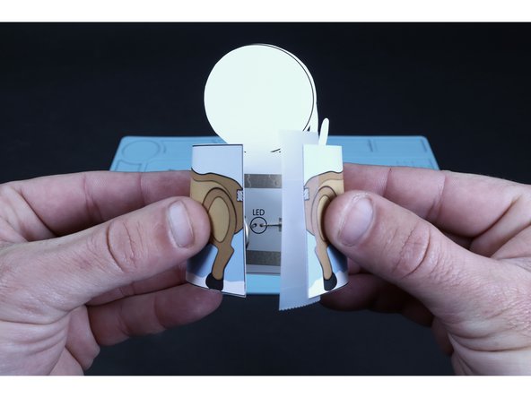 Use a piece of transparent tape to now join the two matching edges together to form the tube shape. 