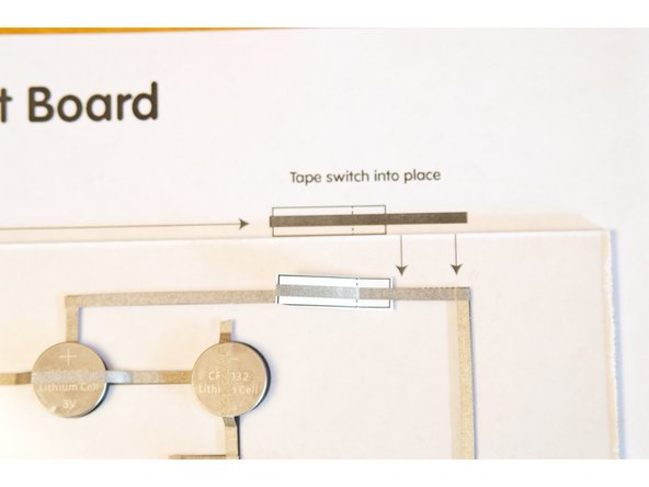 You'll need to tape it down so the &quot;tail&quot; is touching the tape in the upper right corner, and when it folds down it touches the piece of tape across the gap.