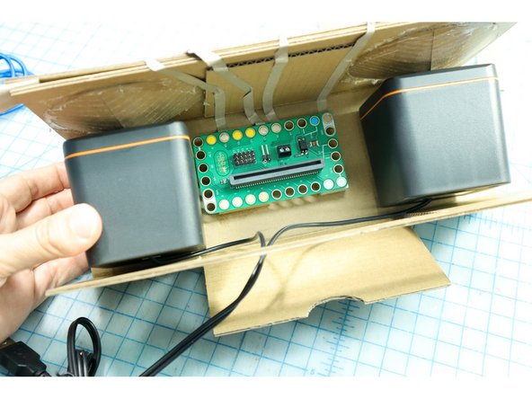 Use foam mounting tape to place the speakers inside the box.