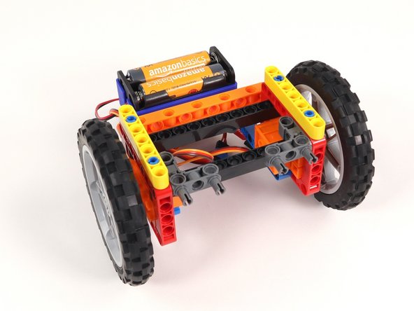 Add a yellow beam onto the blue pins on each side of the Rover