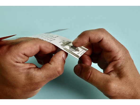 Stick the Battery atop the Tape Loop ‘E.’ with the Positive (+) side up.