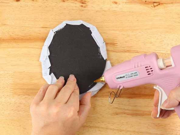 Flip the Mummy over and wrap each strip around to the back. Secure each strip in place with glue.