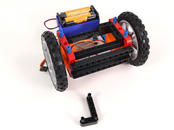 Remove both L-shaped beams and the 3 pins holding them in place.