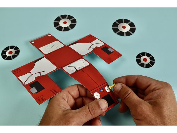 Using a push pin poke holes through the front of the tractor where the LEDs will go.