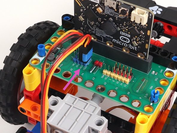 Plug the right servo into the row for Pin 14 of the blue 5V pins, matching the orientation of the servo connector for the left servo.