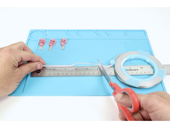 Next, we will need to arrange the molded LEDs in a row and connect them in a specific way. We found it easiest to prepare this arrangement off of the hat first, transferring it to the hat afterward.