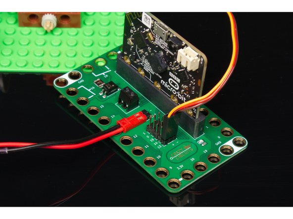 The servo has three wires connected to it that terminate in a black connector plug. This connector is what we will plug into the Bit Board header pins.