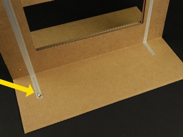 We'll start by making a small loop of tape, then sticking the battery down to it (positive side facing up).