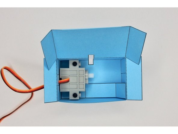 Place the servos in the body and thread the wires through the cut out.