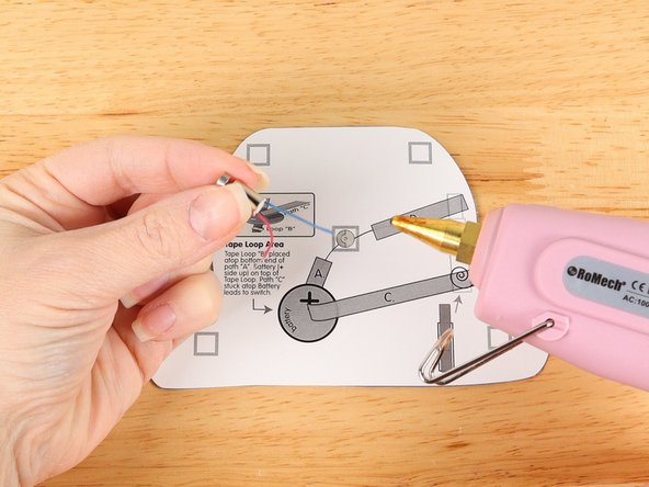 Add hot glue or double-sided foam tape to the center of the bottom template where the motor will go.