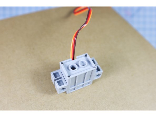 Hot glue the motor in place.