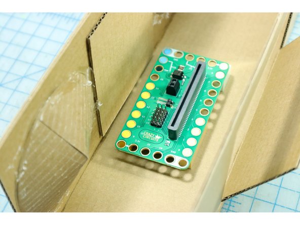Add other LEGO to stabilize the board at the corners, and use superglue to place the board inside the Boom Box.