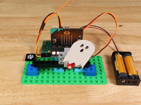 Attach the ghost to the half beam on the servo using tape.
