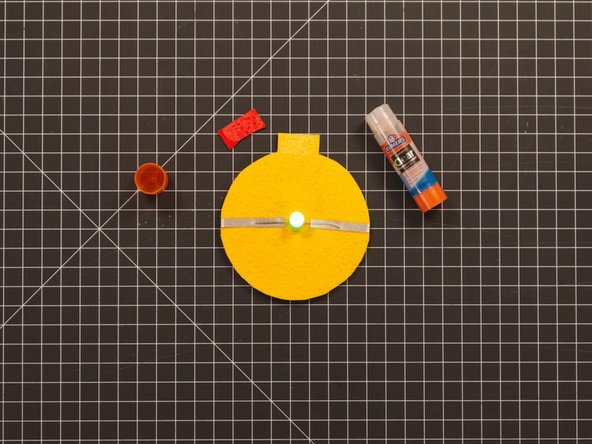 We found that if you use a glue stick it is very helpful to put a bit of glue on both pieces. So cover the cap piece with glue and then put a bit on the area where it will attach.