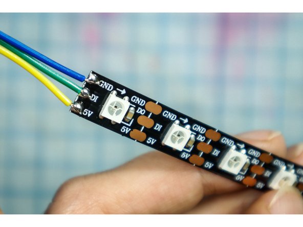 Solder three hookup wires to the +5V, DI, and GND pads on the LED strip.