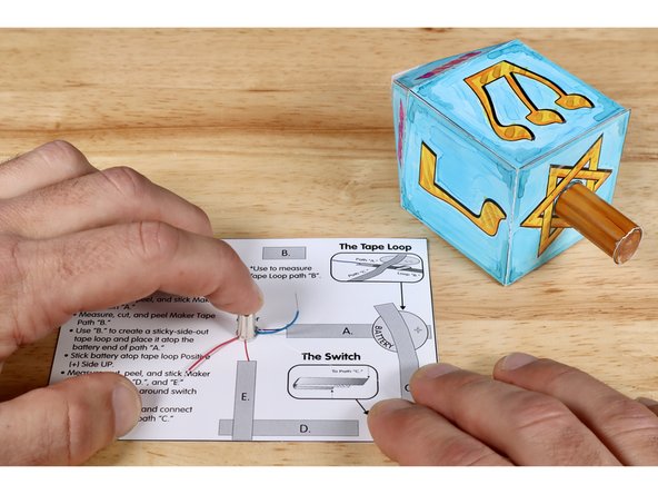 Press the motor into the glue so that it is oriented vertically; motor weight facing UP. Hold the motor in place for a few moments so the glue has a chance to set.