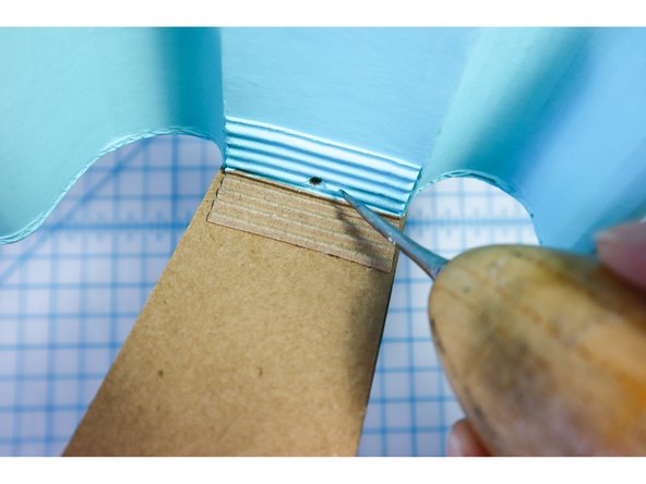 Continue the ground connection down the back of the neck to the Bit Board by placing a hole in the wall as shown.