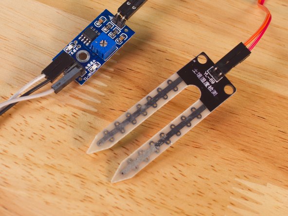 While these Moisture Sensors are cheap (we got a 5 pack for less than $8) they use resistive measurement, which means that eventually one of the probe legs will corrode to the point that it will no longer work. We've got a good workaround though, using Maker Tape!