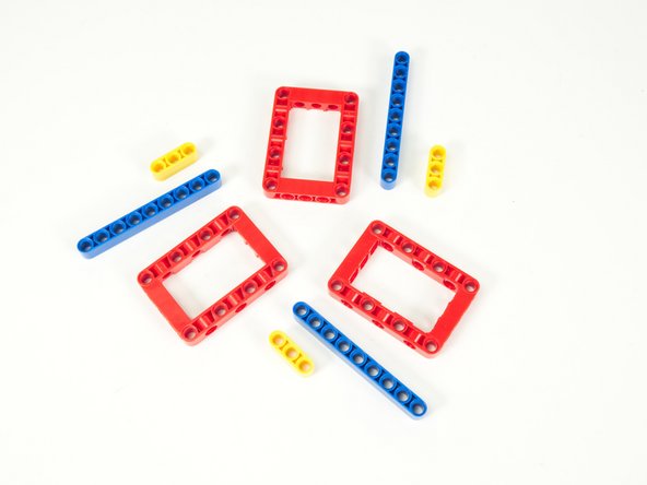 We'll start with 3 red frames, 3 blue 9 hole beams, 3 yellow 3 hole beams, and 12 black pins. (Not shown)