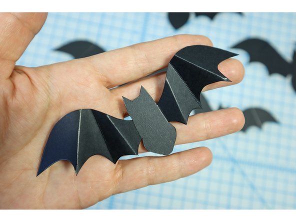 Fold the bat wings back and forth on every other crease like you would a paper fan.
