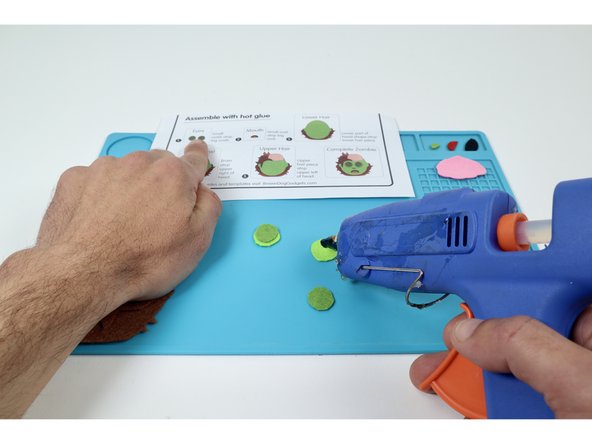 Use the assembly instructions found on the template sheet or these photos along with a hot glue gun to layer each piece correctly and form the final design.