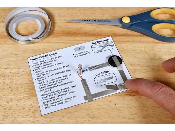Align striped boxes found on both switch and baseplate and connect unattached tape end to path “C.”