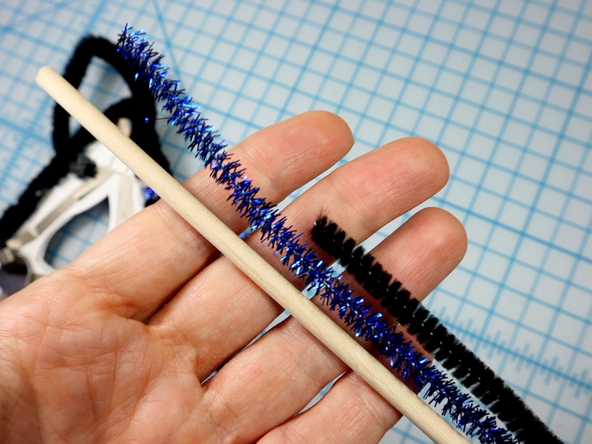 Wrap pipe cleaners around a wooden dowel, then glue the dowel to the back for a masquerade style handheld mask.
