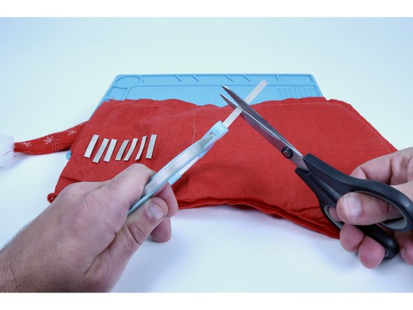 Note: The fuzzy fabric that your stocking is likely made of is an insulator &amp; can prohibit electricity from traveling through the circuit as intended. What we aim to do in the next steps is to A) keep that fuzz off of the LED legs &amp; B) create a bigger contact point for the rest of the circuit paths that need to connect to the legs.